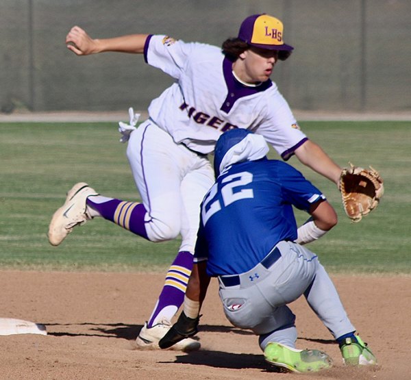 Lemoore's Ian Snell lunges for the ball as Lompoc's Kash Kubasaciwiecz steals second in the second inning.